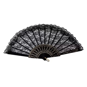 Close-up of black lace folding fan with intricate floral patterns and golden ring detail
