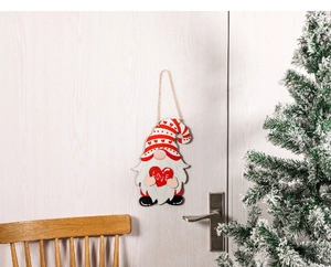 Detail of wooden gnome ornament with red love heart and jute string hanging decoration