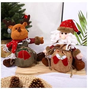 Close-up of festive reindeer and Santa drawstring gift bags with knitting details