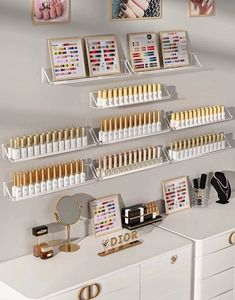 Close-up of wall-mounted clear acrylic nail polish display shelves in a neat arrangement