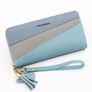 Women long patchwork zip wallet with tassel charm and wristlet in blue and grey tones