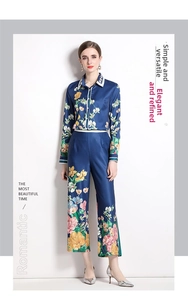 Detail of elegant navy blue satin blouse and floral wide leg pants two piece set for women