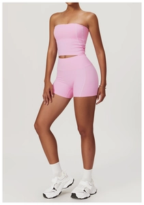 Detailed view of pink yoga set featuring a tight-fitting top and high-waist sports shorts