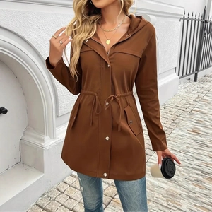 Detail of caramel parka jacket featuring adjustable drawstring waist and metal hardware