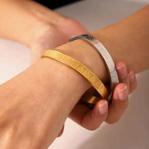 Minimalist Roman numeral titanium steel bangle in gold and silver finish for women