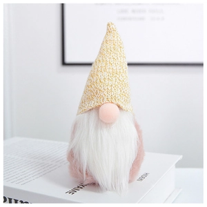 Close-up of Nordic pink gnome plush ornament with long beard on white books decor