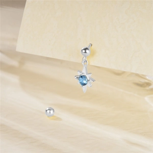 Detail of s925 silver stud earring featuring light blue zircon star and screw ball back