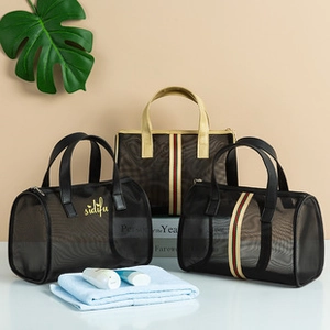 Close-up of mesh travel toiletry bags with zipper closure and striped decorative straps