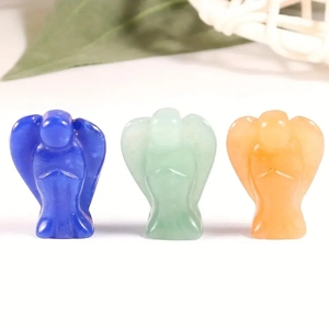 Three hand-carved natural crystal angel figurines in blue, green, and orange stones