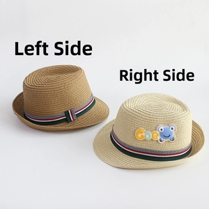 Detail of kids straw hats with striped bands and cartoon frog patch in brown and beige