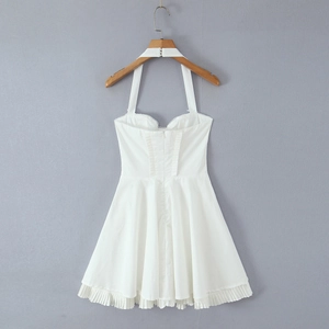 White halter neck dress with cinched waist and pleated skirt on a wooden hanger