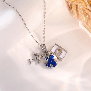 Detail of travel-themed necklace with silver airplane, globe, and camera pendants