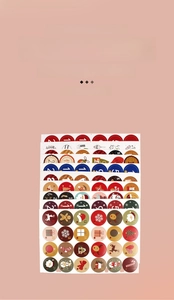 Close-up of 24-day Christmas advent calendar stickers with festive Santa and reindeer motifs