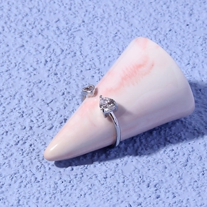 Detail view of silver heart ring with sparkling heart-shaped zircon and open band design