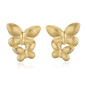 Detailed view of golden butterfly stud earrings with textured wings on a white base