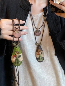 Detailed shot of ethnic bohemian drop necklaces with bow and tassel accents for winter.