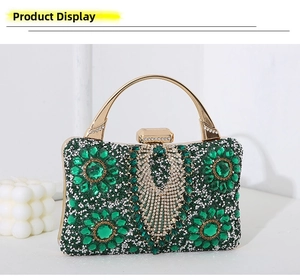 Detailed view of emerald crystal evening bag with gold metal handle and teardrop gems