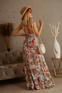Detail of red paisley bohemian maxi dress with backless halter design for women