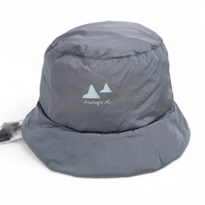 Detailed view of dark gray quilted bucket hat with printed logo and waterproof fabric