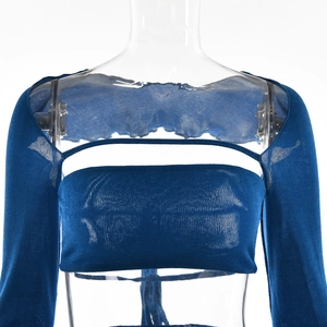 Detail view of blue three-piece knit set featuring bandeau top and long sleeve shrug