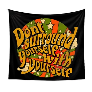 Detailed view of black fabric tapestry with vintage quote pattern and stars decoration