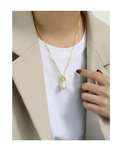 Detail of S925 silver necklace featuring a baroque freshwater pearl with golden toggle clasp