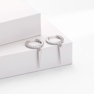 Macro detail of S925 sterling silver hoop earrings with zircon paving and cone pendants