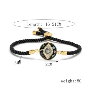 Detail showing adjustable evil eye woven bracelet with blue zircon and gold finish