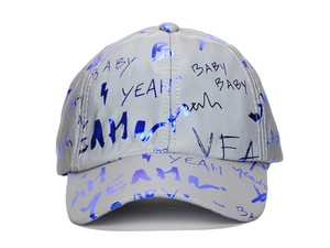 Close-up of hip-hop baseball cap with blue graffiti letters and trendy urban patterns