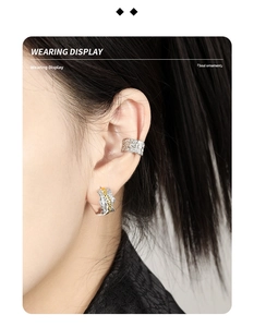 Detailed close-up of textured S925 silver ear cuff and two-tone wavy hoop earrings on a model