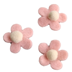 Three handmade pink wool felt flower ornaments with cream centers for Christmas decor