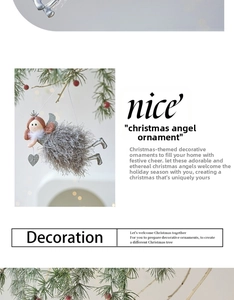 Detail of a Christmas angel ornament with silver feather dress and sequin wings on a tree