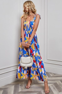 Detail of floral backless sundress with bow shoulder straps and vibrant blue flower print