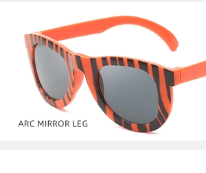 Close-up of children's camouflage glasses with orange tiger stripes and arc mirror legs