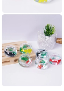 Detailed close-up of six miniature glass fishbowl charms with colorful koi and green plants