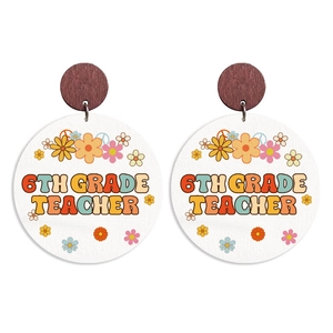 Macro detail of wooden earrings with 6th Grade Teacher floral print on white circle charms