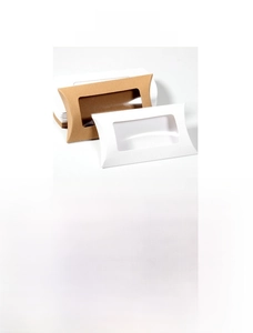 Detail view of pillow-shaped kraft paper candy boxes with transparent PVC window for wedding gifts