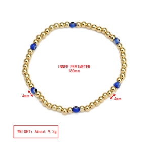 Detailed view of evil eye beaded bracelet with 4mm gold beads and blue resin eyes