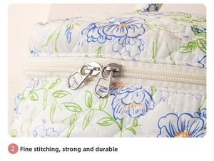 Detail of dual metal zippers and quilting process on the floral cotton makeup bag