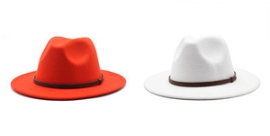 Detail of red and white wool fedora hats with vintage brown leather decorative bands