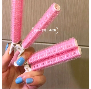 Close-up of pink plastic hair root clips with nylon hook surface for hair styling