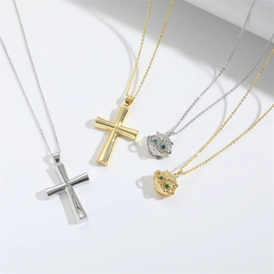 Minimalist gold and silver cross and owl pendant necklaces with green gemstone accents
