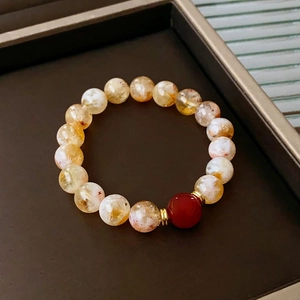 Macro view of crystal fluorite beaded bracelet with gold spacers in a jewelry display box