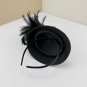 Detailed view of black vintage feather fascinator with headband for elegant events