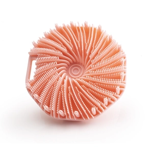 Pink silicone body scrubber brush with spiral bristles and hanging hole for exfoliation