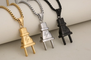 Detailed shot of hip hop power plug pendants in gold, silver, and black stainless steel
