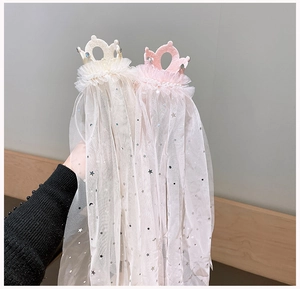 Close-up of crown headbands with sequins star tulle veil in pink and beige colors