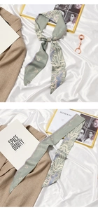 Detail of light green silk scarf with geometric prints and I Love You lettering