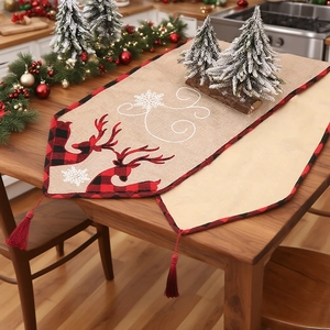 Linen Christmas table runner with embroidered reindeer, buffalo plaid, and red tassels