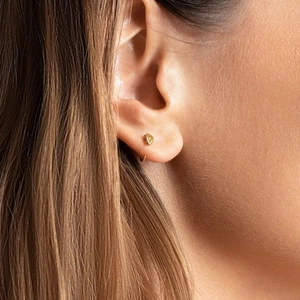 Close-up of a gold-plated S925 sterling silver snake ear cuff worn on a female ear model